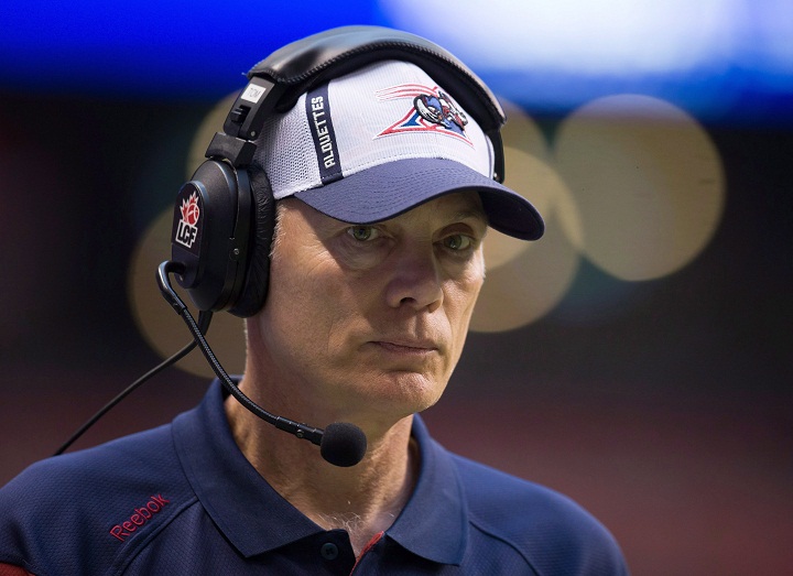 In this file photo, Montreal Alouettes head coach Tom Higgins watches from the sideline while playing the B.C. Lions during the first half of a CFL football game in Vancouver, B.C., on Thursday August 20, 2015. Higgins has been fired as head coach of the Montreal Alouettes and general manager Jim Popp will take over the job for the fourth time in his career. 