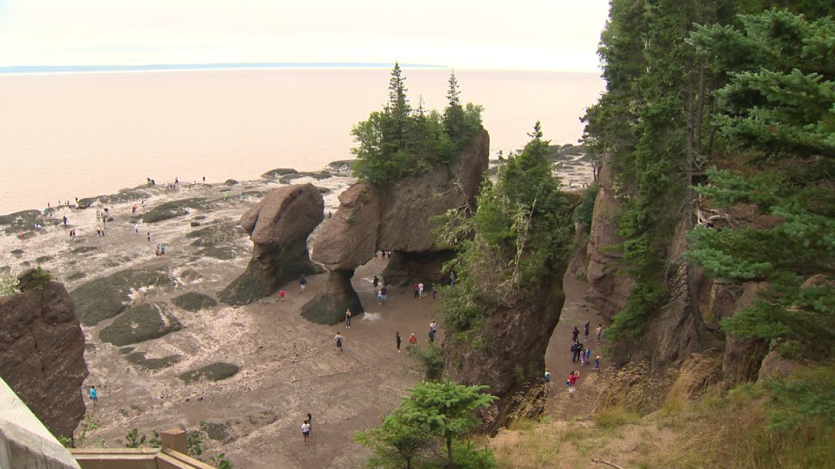 Visitors take in Hopewell Rocks in New Brunswick on Thursday, Aug. 20, 2015.