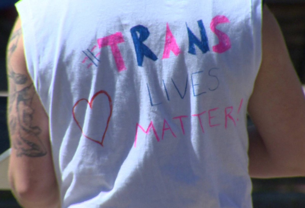 #TransLivesMatter seen on the back of a supporter's shirt.