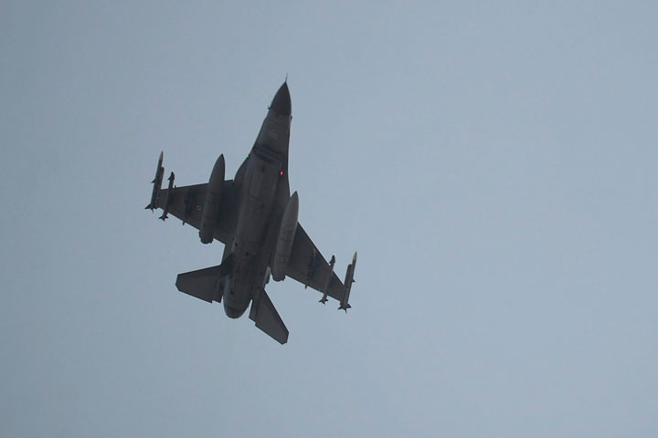 A Turkish Air Force fighter plane flies over the Incirlik Air Base, in Adana, southern Turkey, Thursday, Aug. 13, 2015.