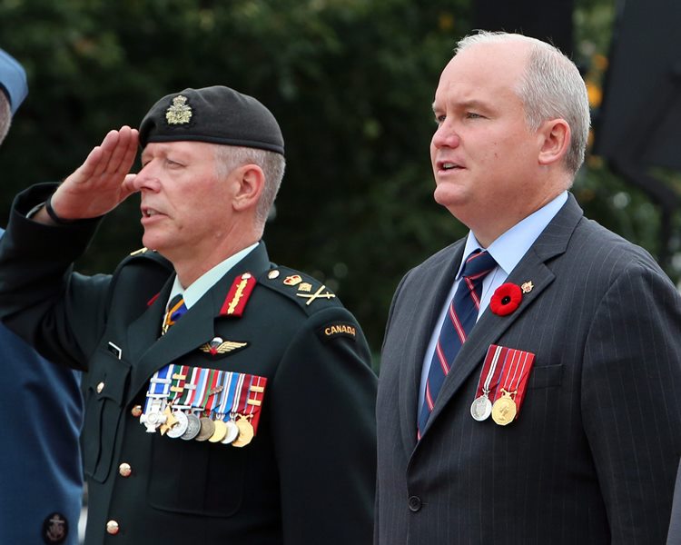 National Defence Chief Jonathan Vance, left, and Veterans Affairs Minister Erin O'Toole take part in a commemoration ceremony of the 70th anniversary of the end of the Second World War in the Far East, or V-J Day (Victory Over Japan) at the National War Memorial in Ottawa on Saturday, August 15, 2015. 