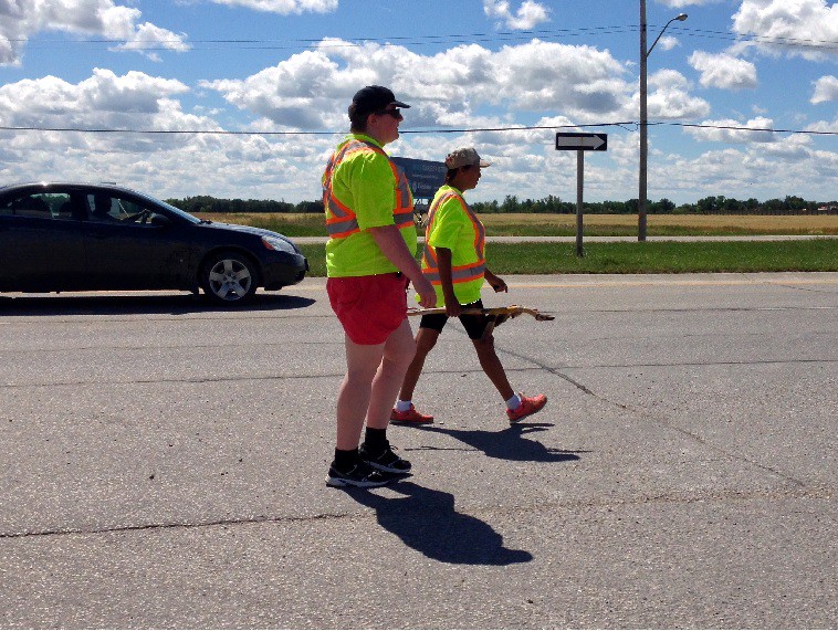 Brenda Osborne and a friend walking along Highway No. 1 Monday to raise awareness for missing and murdered women and men.
