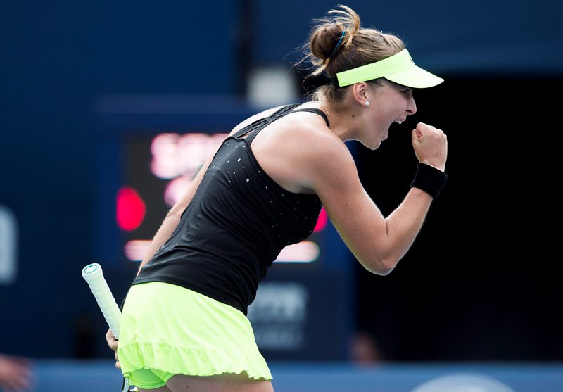 Belinda Bencic, of Switzerland, celebrates after winning the first set against Simona Halep, of Romania, during the women's final at the Rogers Cup tennis tournament in Toronto on Sunday, August 16, 2015.