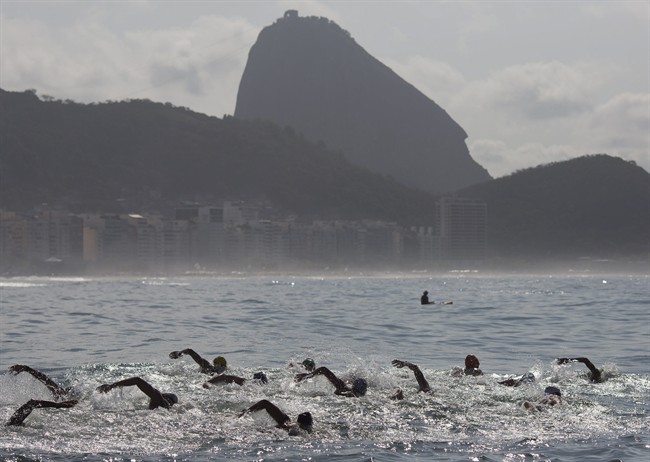 Backdropped by Sugar Loaf Mountain, athletes compete in the men's marathon swimming test event, ahead of the Rio 2016 Olympic Games, at Copacabana Beach, Rio de Janeiro, Brazil, Saturday, Aug. 22, 2015.