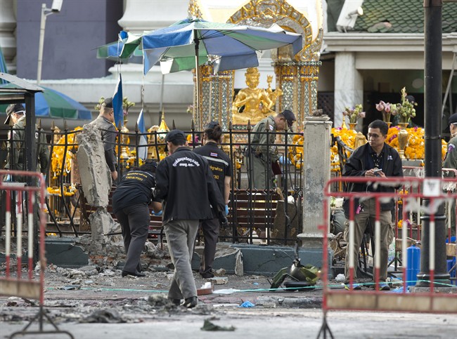 Police investigate a scene the morning after an explosion in Bangkok,Thailand, Tuesday, Aug. 18, 2015. A bomb exploded Monday within a central Bangkok shrine that is among the city's most popular tourist spots killing a number of people and injuring others, police said. (AP Photo/Mark Baker).