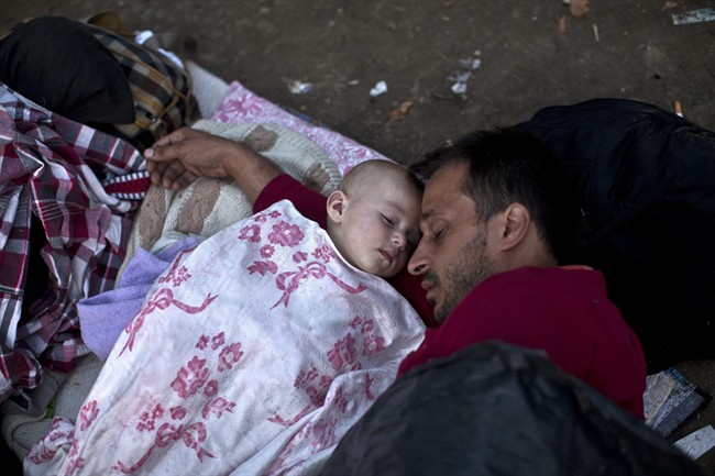 Migrants from Syria sleep at a park in Belgrade, Serbia, Thursday, Aug. 27, 2015. 