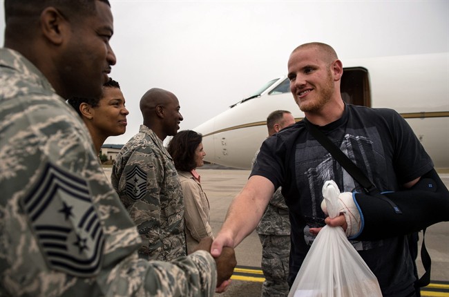 In this Aug. 24, 2015 picture, provided by U.S, Airforce Ramstein , Air Force Airman 1st Class Spencer Stone , right, meets Chief Master Sgt. Phillip Easton, 86th Airlift Wing command chief, upon his arrival to Ramstein Air Base, Germany. Stone, along with childhood friends Aleksander Skarlatos and Anthony Sadler, was recently honored by French President François Hollande with the French Legion of Honour for subduing an armed gunman when he entered their train carrying an assault rifle, a handgun and a box cutter. Stone is an ambulance service technician with the 65th Medical Operations Squadron stationed at Lajes Field, Azores. (Staff Sgt. Sara Keller/U.S. Air Force via AP) .