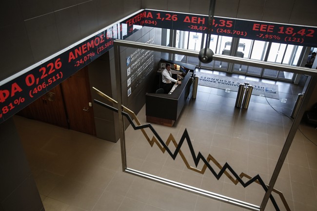 An employee of the Athens' Stock Exchange stands behind a reception desk in Athens, Greece, on Monday, Aug. 3, 2015. Greece's main stock index plunged over 22 percent as it reopened Monday after a five-week closure, giving investors their first opportunity since June to react to the country's latest economic crisis. (AP Photo/Yorgos Karahalis).
