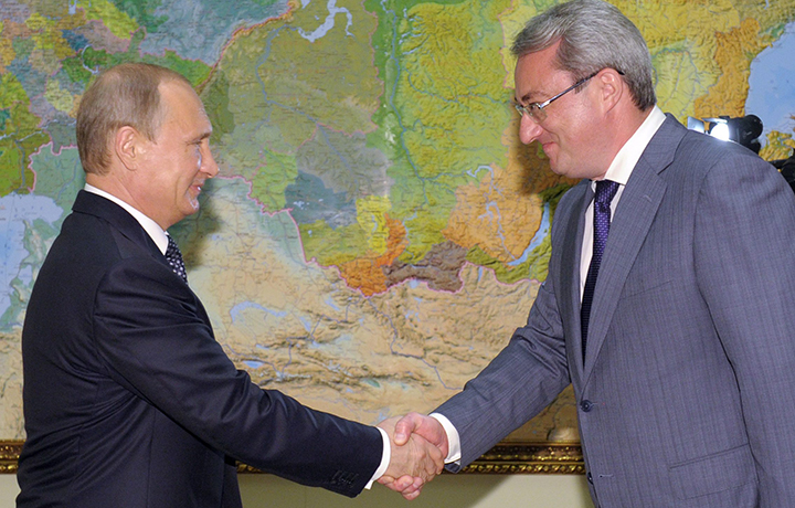 Russia's president Vladimir Putin and Republic of Komi head Vyacheslav Gaizer shake hands during a meeting at Bocharov ruchei residence.