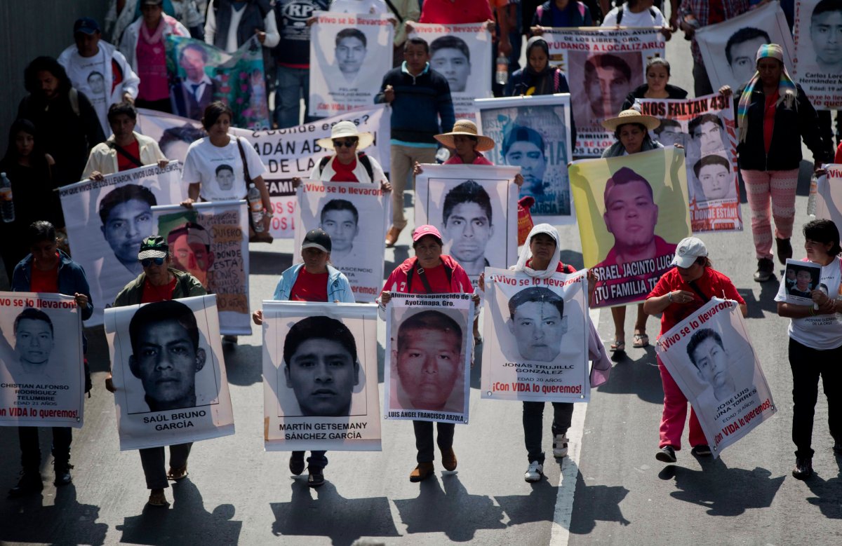 In this Jan. 26, 2015 file photo, relatives and protestors carry pictures of some of the 43 students who went missing in Sept. 26, 2014 from a rural teachers college in Guerrero state, during a march in Mexico City. 