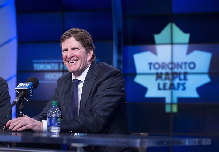 Toronto Maple Leafs' new head coach Mike Babcock laughs during a press conference in Toronto on Thursday, May 21, 2015. THE CANADIAN PRESS/Darren Calabrese.