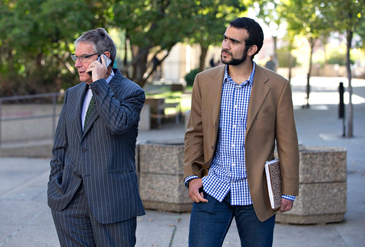 Dennis Edney, left, and Omar Khadr wait for their ride after a bail conditions hearing in Edmonton on Friday, September 11, 2015. 