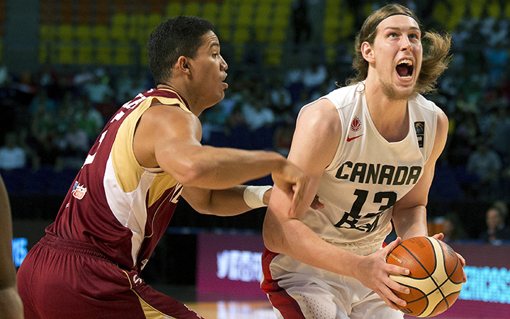 Canada's Kelly Olynyk, left, looks to shoot under pressure from Venezuela's Windi Graterol, during a FIBA Americas Championship basketball game in Mexico City, Friday, Sept. 11, 2015.