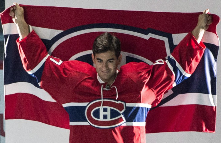 Montreal Canadiens Max Pacioretty holds up a team banner for a photo session on the first day of training camp Thursday, September 17, 2015 in Brossard, Que.