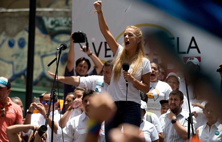 Lilian Tintori, wife of jailed opposition leader Leopoldo Lopez, cheers to supporters during a rally in Caracas, Venezuela, Saturday, Sept. 19, 2015. 