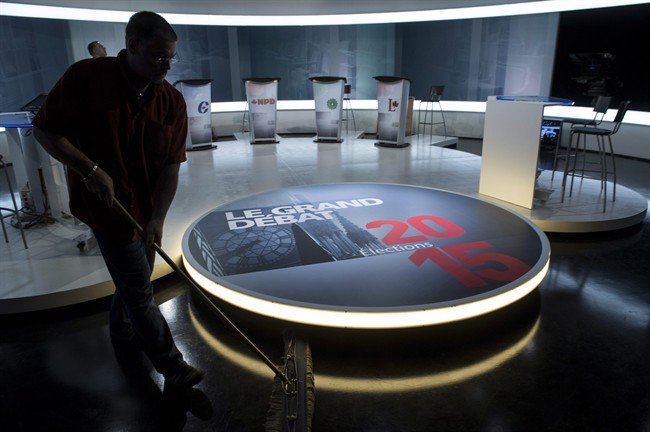 A technician cleans the set in preparation for Thursday night's French language leaders debate Wednesday, September 23, 2015 in Montreal.