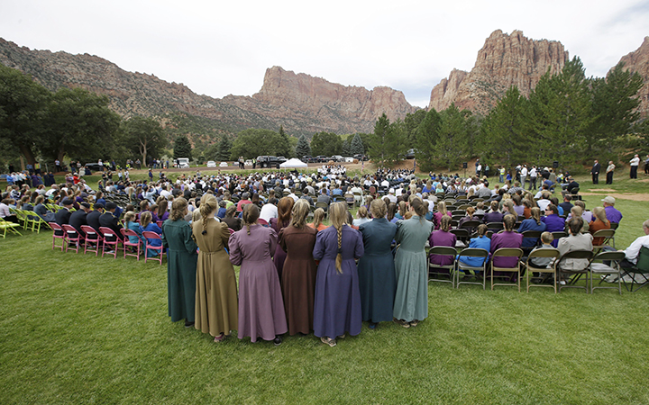 Community members from Hildale, Utah, and Colorado City, Ariz., attend a memorial service on Saturday, Sept. 26, 2015 for 12 women and children swept away in a deadly flash flood nearly two weeks earlier on the Utah-Arizona border. One six-year-old boy is still missing. 