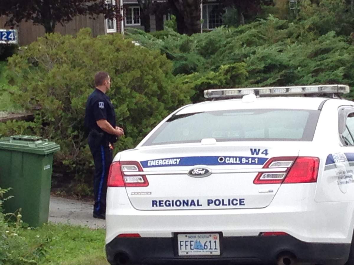 A member of Halifax Regional Police secures the home while officers wait for a search warrant.