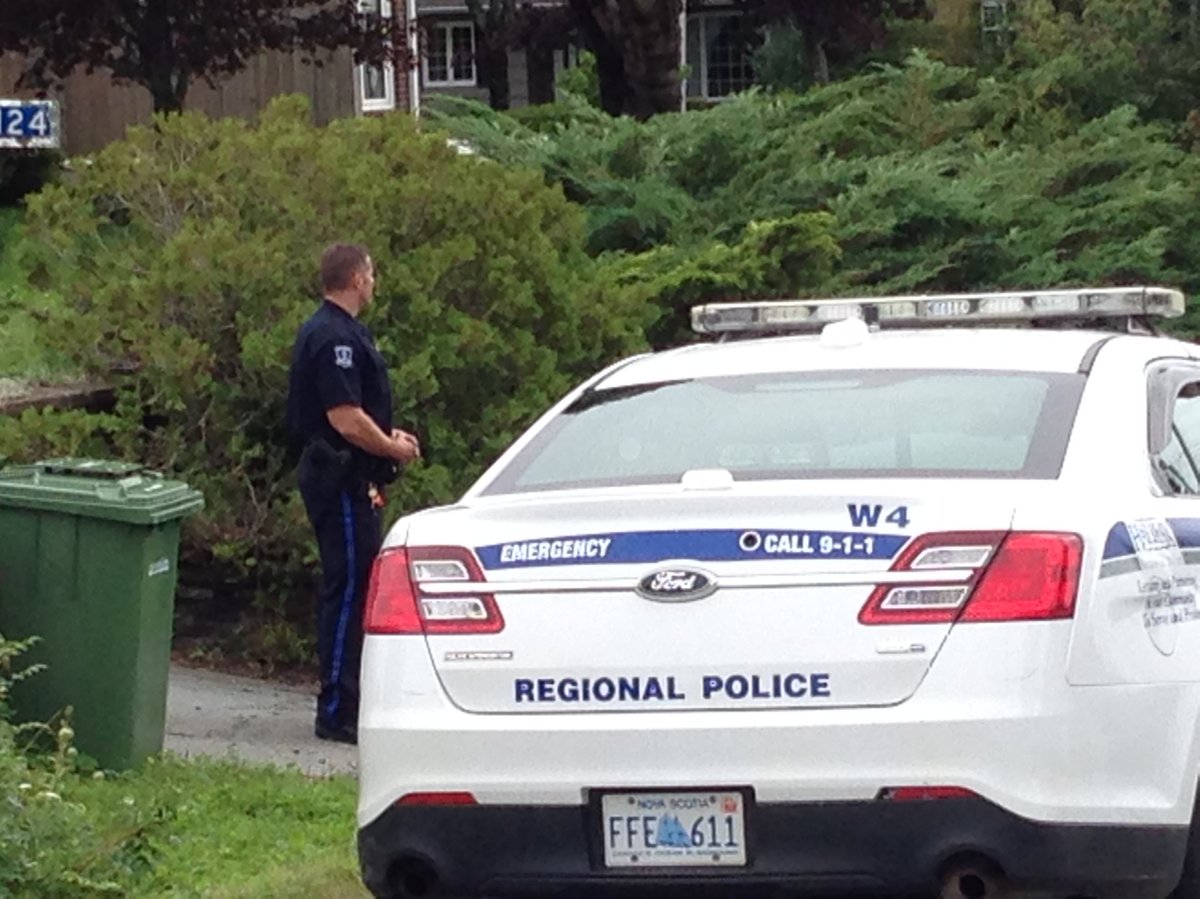 A member of the Halifax Regional Police secures a home in Williamswood.