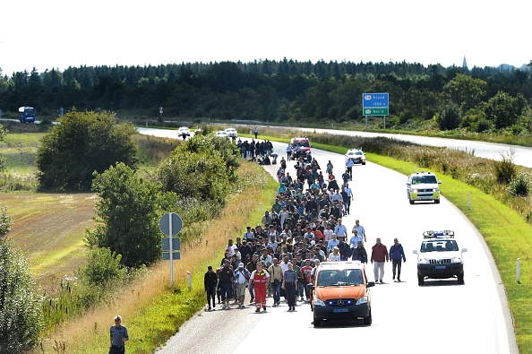 Migrants, mainly from Syria and Iraq, walk at the E45 freeway from Padborg, on the Danish-German border, heading north to try to get to Sweden on September 9, 2015. 