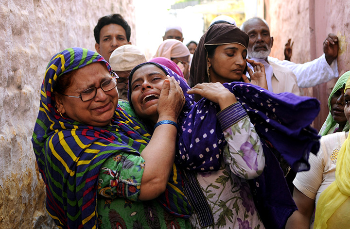 In this photograph taken on September 29, 2015, relatives mourn slain Indian villager Mohammad Akhlaq in the village of Bisada, some 35 kilometres north-east of New Delhi.