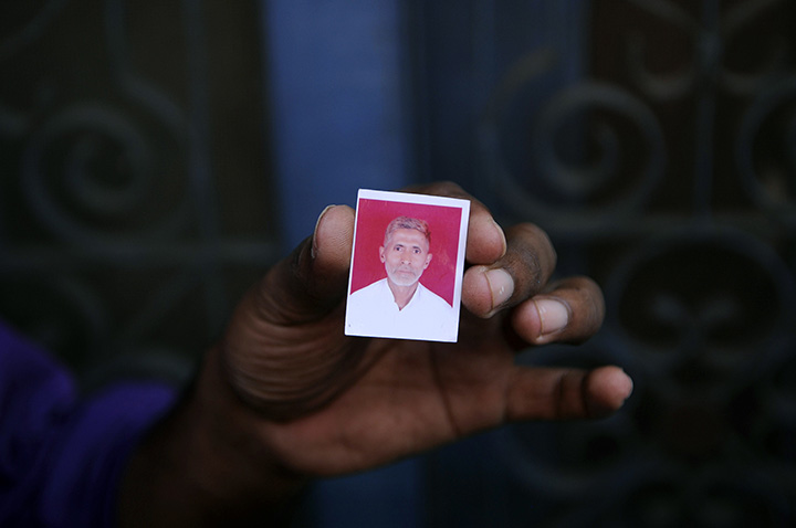 In this photograph taken on September 29, 2015, a relative holds a photograph of slain Indian villager Mohammad Akhlaq at his home in the village of Bisada, some 35 kilometres north-east of New Delhi.   