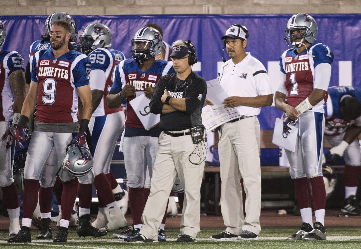 Montreal Alouettes' general manager and head coach Jim Popp, centre, looks on from the sidelines alongside Anthony Calvillo during first half CFL football action against the BC Lions in Montreal on September 3, 2015. The Montreal Alouettes shook up their coaching staff once again by firing offensive co-ordinator Turk Schonert.