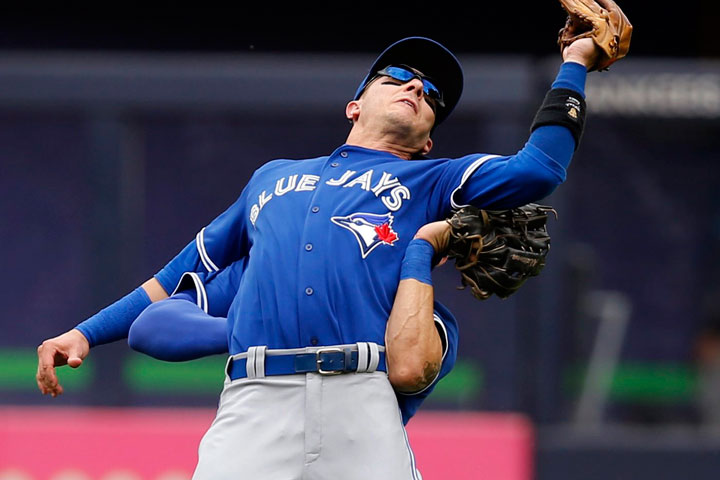 Toronto Blue Jays shortstop Troy Tulowitzki, foreground, collides with Blue Jays center fielder Kevin Pillar fielding a fly ball in a baseball game at Yankee Stadium in New York, Saturday, Sept. 12, 2015. 