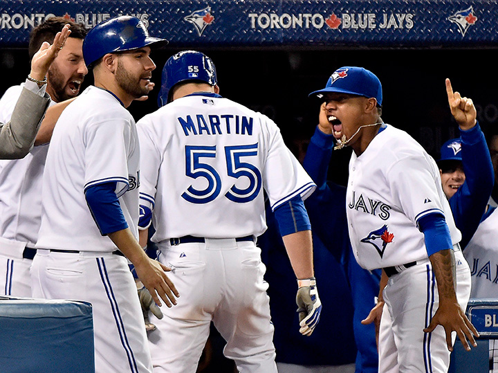Toronto Blue Jays catcher Russell Martin celebrates with Blue Jays pitcher Marcus Stroman, right, after hitting a three run home run against the New York Yankees during seventh inning AL baseball action in Toronto on Wednesday, September 23, 2015. 