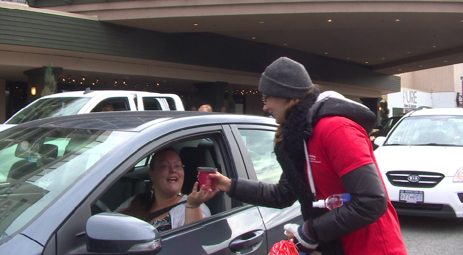 Volunteer Amberlee Erdmann hands out hot coffee to drivers at the 4th Annual United Way Drive Thru Breakfast.