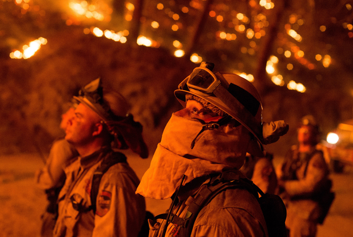 Firefighters monitor a backfire while battling the Butte fire near San Andreas, California on September 12, 2015. 