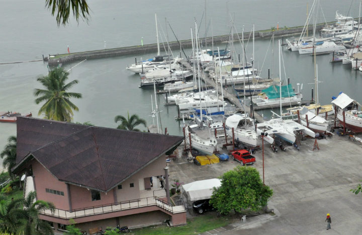 A man walks inside the compound of Holiday Ocean View Samal Resort, on Samal Island in southern Philippines Tuesday, Sept. 22, 2015, a day after unidentified gunmen abducted a Norwegian resort manager, two Canadians and a Filipino woman from this southern Philippine island, the military and police said.