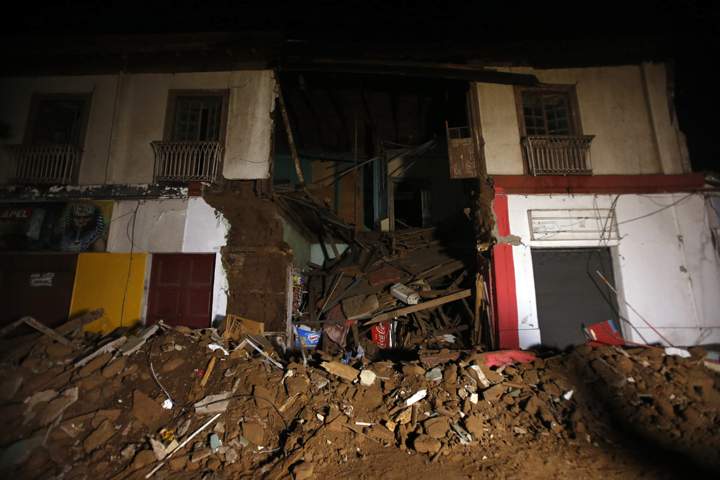 Debris of a destroyed house sit on a street in Illapel, Chile, Thursday, Sept. 17, 2015.