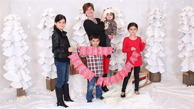 Alison Azer, centre, holds Meitan as her other children Sharvahn, left to right, Dersim and Rojevahn pose for photo in this family handout image. Azer has not seen her children since August, 2015.
