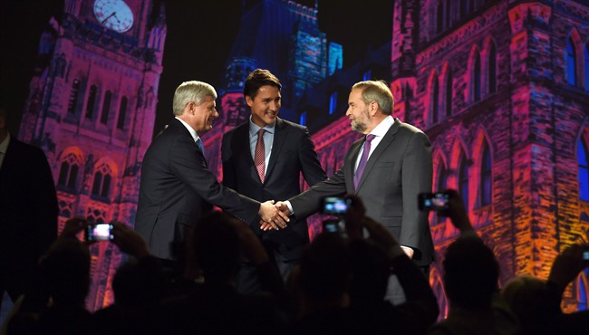 FILE PHOTO: Conservative leader Stephen Harper, left, and NDP leader Tom Mulcair shake hands as Liberal leader Justin Trudeau looks on during their introduction prior to the leaders' debate in Calgary on September 17, 2015.