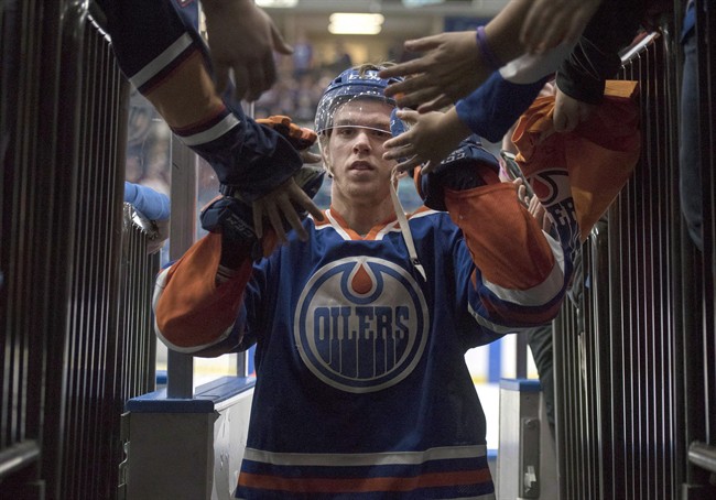Edmonton Oilers' Connor McDavid leaves the ice after being name the first star of the game as the Oilers defeated the Minnesota Wild in NHL pre-season hockey game in Saskatoon, Saturday, September 26, 2015. McDavid is already helping the Edmonton Oilers off the ice.Even before the start of the NHL regular season, the addition of the top draft pick has seen Oilers' ticket sales climb 131 per cent compared to last year on the secondary market, according to StubHub.com. 