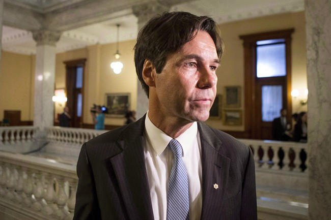 Eric Hoskins makes his way to a cabinet briefing after being sworn in as Ontario health minister at Queens Park in Toronto on June 24, 2014.