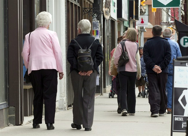 Senior citizens make their way down a street in Peterborough, Ont. on Monday May 7, 2012.