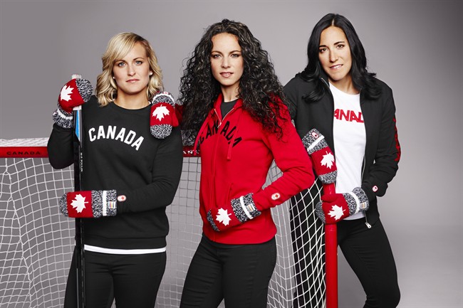 Canadian women's hockey team members Marie-Philip Poulin, left to right, Shannon Szabados and Caroline Ouellette pose as they show off the seventh edition of the Hudson's Bay Olympic red mittens in this undated handout photo.