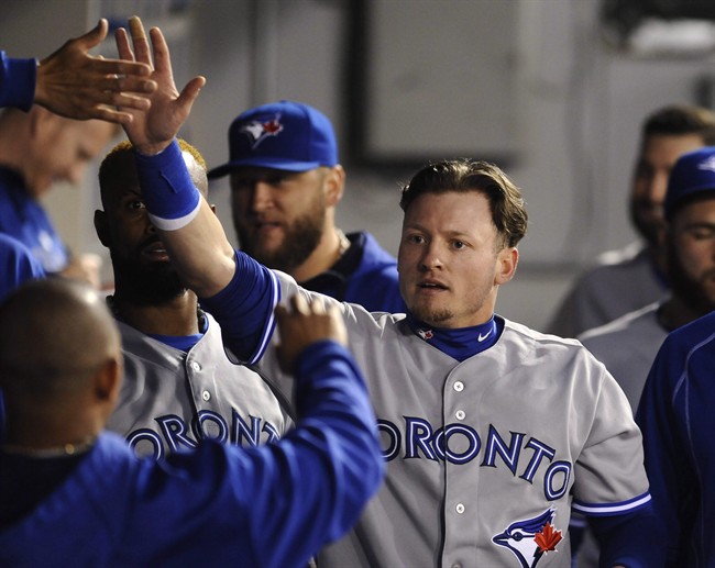 Toronto Blue Jays' Josh Donaldson celebrates with teammates after he scored.