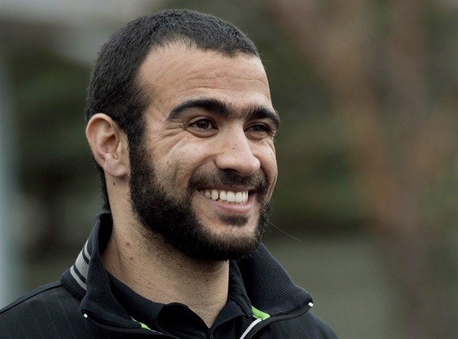 Omar Khadr smiles as he speaks to the media after being granted bail in Edmonton on Thursday, May 7, 2015. Lawyers for former Guantanamo Bay prisoner Omar Khadr are to be in court Friday to argue for an ease in his bail conditions. THE CANADIAN PRESS/Nathan Denette.