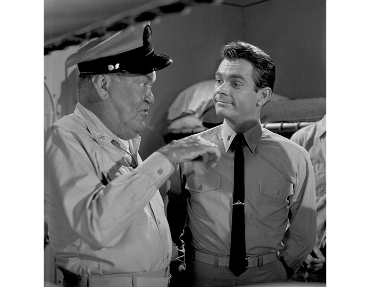 In this March 28, 1963 file photo, co-stars Jay C. Flippen, left, and Dean Jones go through a comedy routine for the “Ensign O’Toole” show, in Los Angeles.