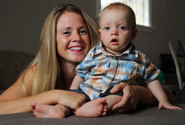 Lindsay Ferris-McVey poses with her 10-month-old son Henley at their home in London, Ont., Friday September 4, 2015. Ferris-McVey chose not to have her son Henley "snipped" after his birth late last year, although her husband is circumcised.