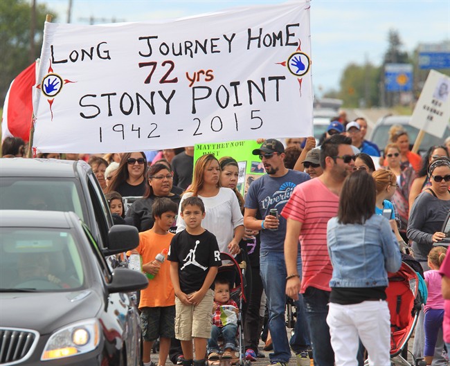 Members of the Kettle and Stony Point First Nation march along the highway during a "Going Home Walk" to the gates of the former Camp Ipperwash on Sunday, Sept. 20, 2015, in London, Ont.