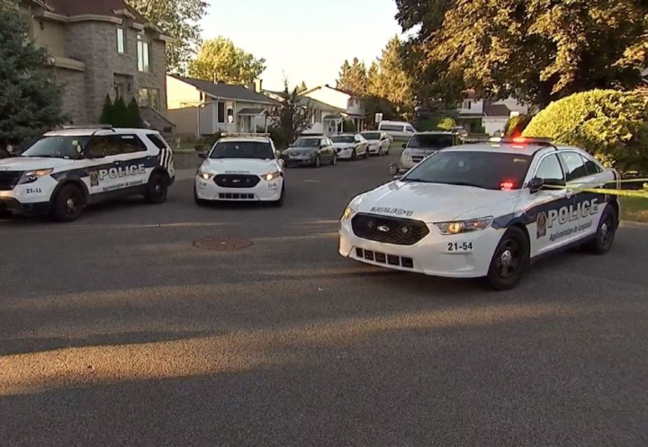 Police officers arrive on the scene after a girl was bitten by a dog in Brossard, Sunday, September 20, 2015.