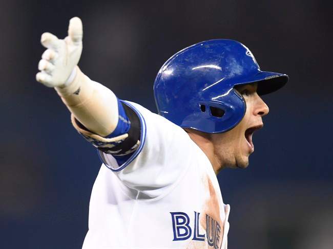 Toronto Blue Jays' Ryan Goins celebrates his walk off home run against the Cleveland Indians as he rounds first base during tenth inning American League baseball action in Toronto on Tuesday, Sept.1, 2015.