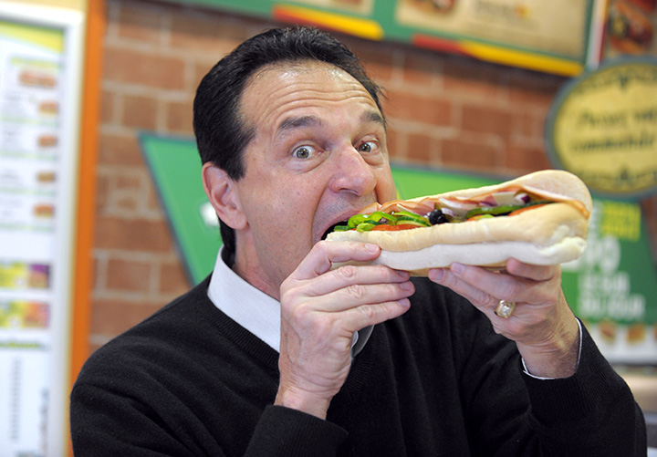 U.S. sandwich maker Subway co-founder Fred DeLuca poses with a sandwich in a Parisian Subway restaurant on June 17, 2011.  