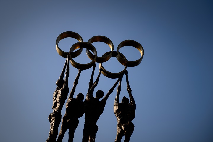 A statue representing people carrying the Olympic Rings is seen on December 10, 2013 at International Olympic Committee (IOC) headquarters in Lausanne. 