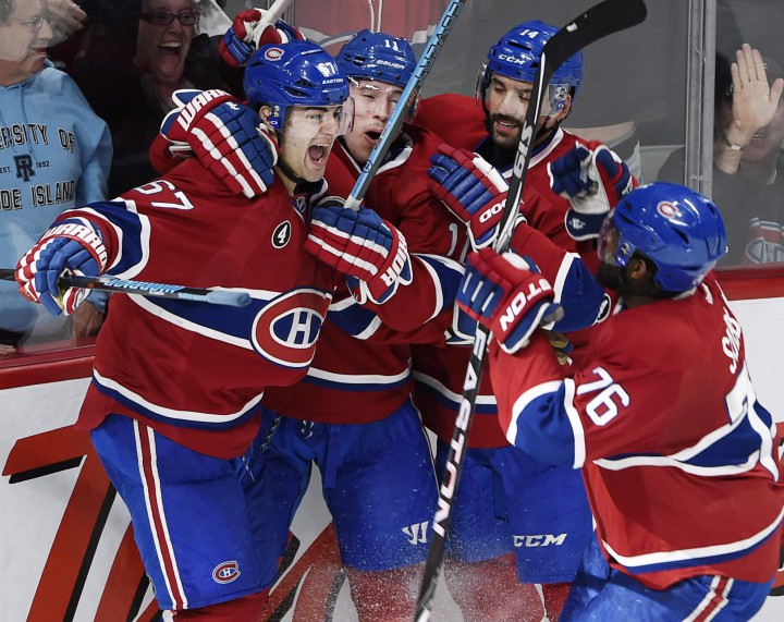 Montreal Canadiens left wing Max Pacioretty, left, celebrates with teammates Brendan Gallagher 2nd left, Tomas Plekanec and P.K. Subban, right, after scoring the tying goal during third period of Game 1 NHL second round playoff hockey action against the Tampa Bay Lightning Friday, May 1, 2015 in Montreal.
