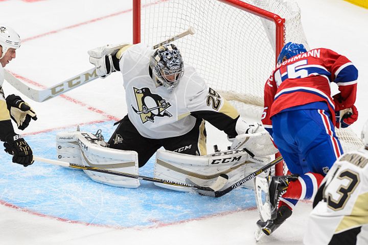 QUEBEC CITY, QC - SEPTEMBER 28:  Tomas Fleischmann #15 of the Montreal Canadiens gets a shot on goaltender Marc-Andre Fleury #29 of the Pittsburgh Penguins during the NHL pre-season game at the Videotron Centre on September 28, 2015 in Quebec City, Quebec, Canada. 